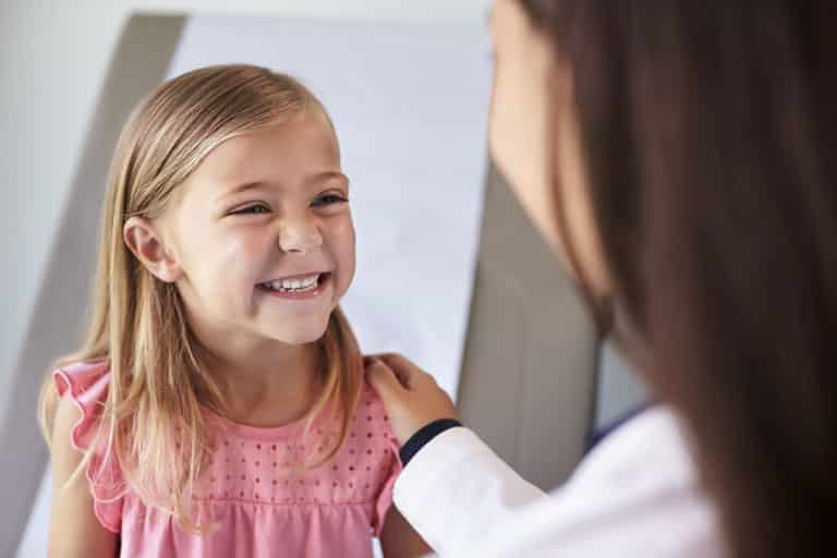 paediatrician with happy child - kids gp doctor