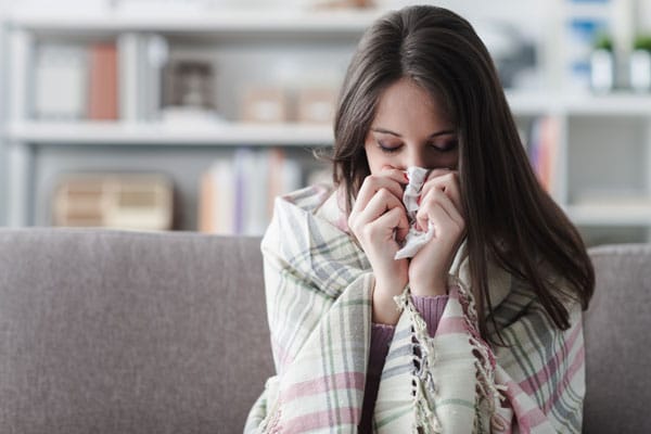 sick woman with flu vaccine