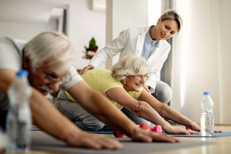 NDIS couple doing stretching exercises at home