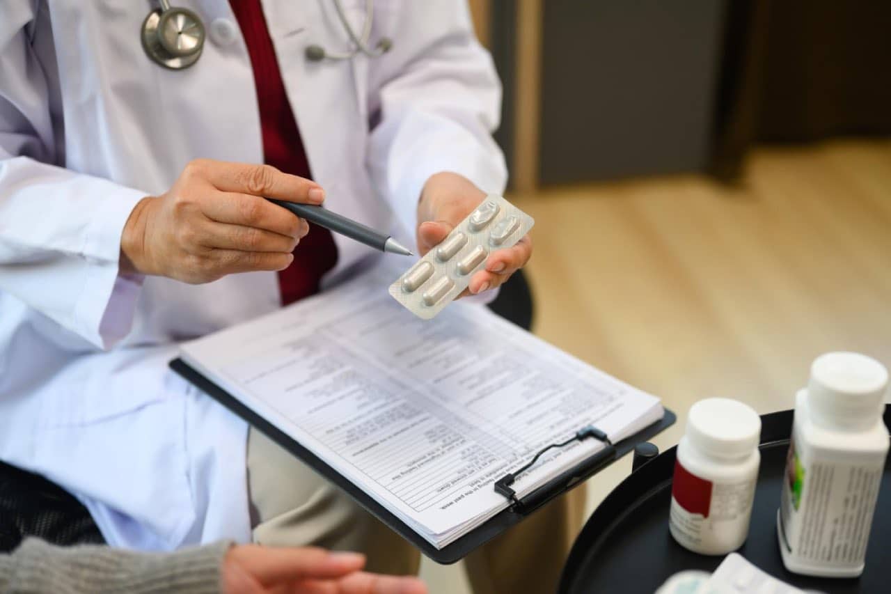 Doctor explaining travel medication to patients who is intended to travel overseas.