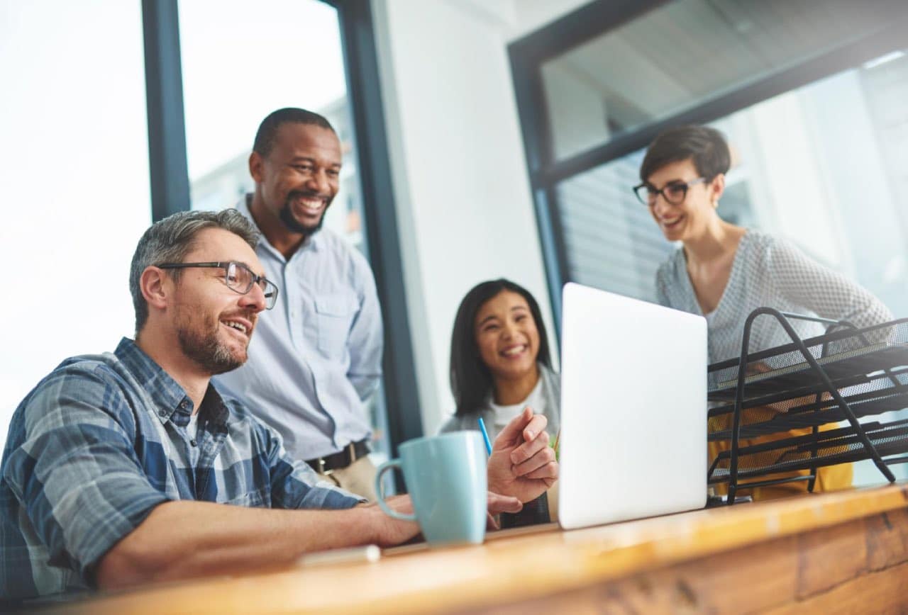 A team of happy workers working together in a safe and healthy office.