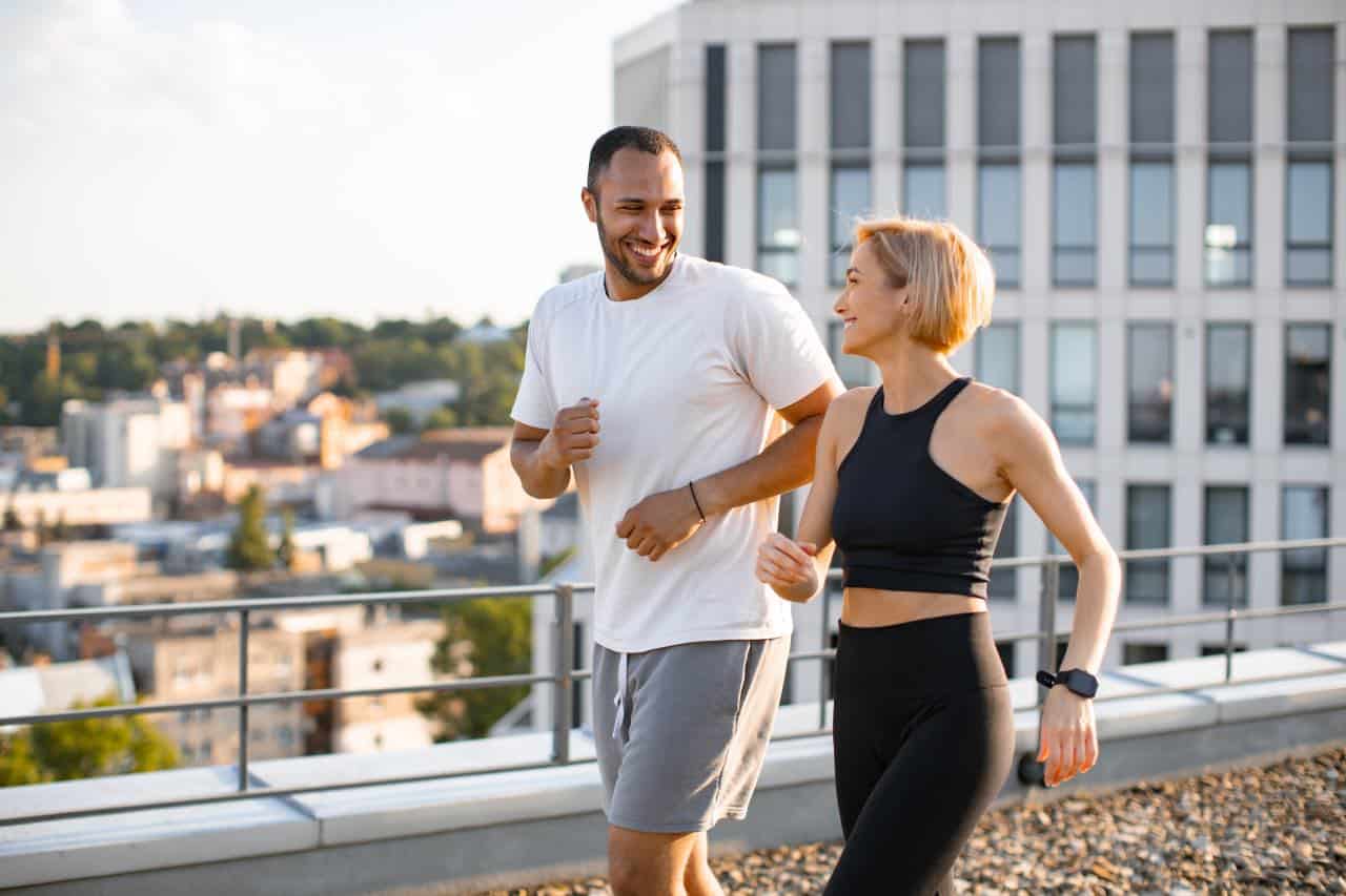 A young couple running together to keep fit and a healthy lifestyle to start a family.