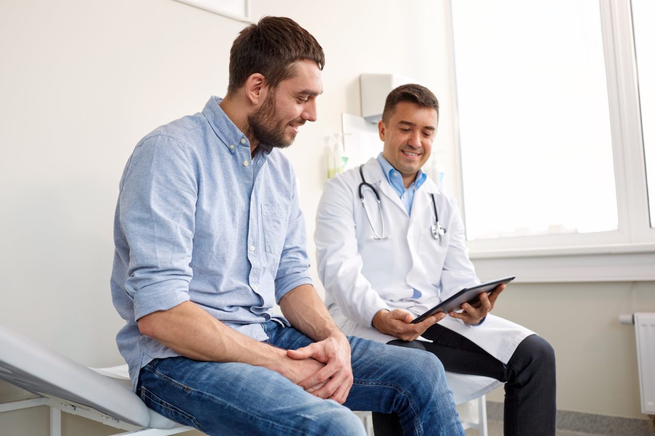 A man checking his health results with the doctor before starting a family