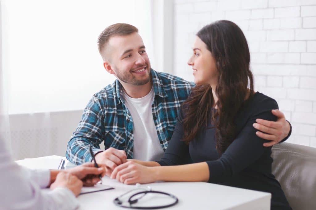 A young couple consulting with doctor on starting a family