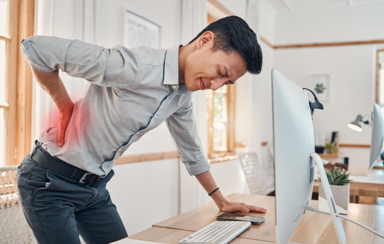 An Asian man suffering lower back pain