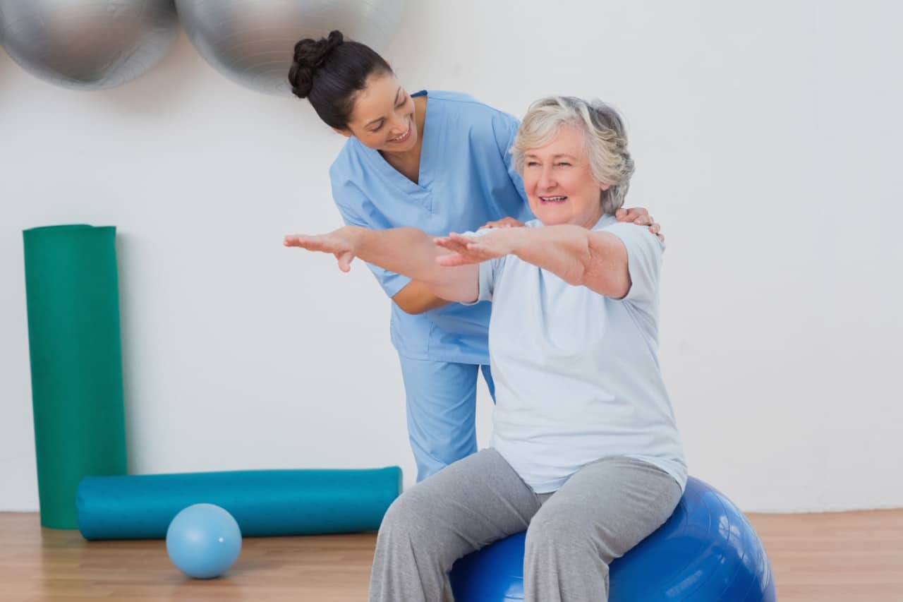 Physiotherapist showing a patient how to work on balancing