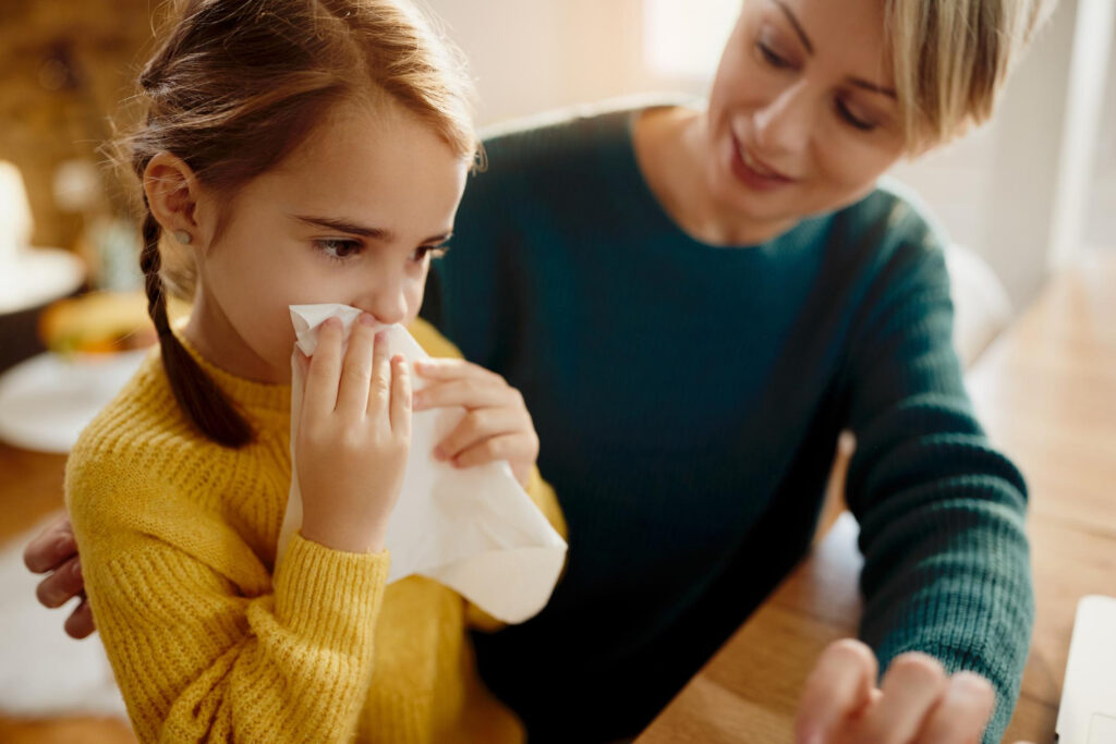 sick child with flu and parent providing support