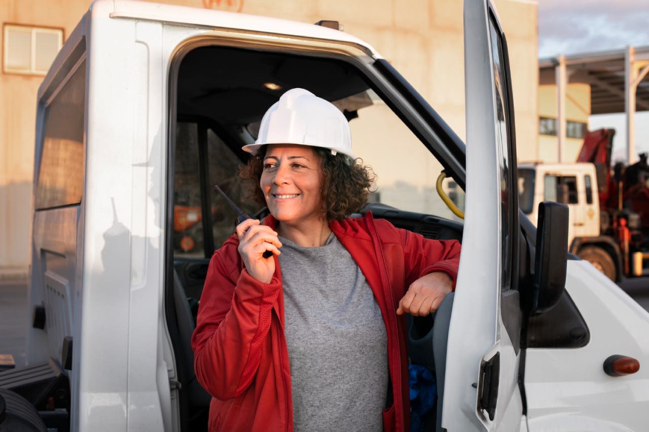 Female delivery driver wearing long sleeve uv jacket for sun protection from skin cancer risks.