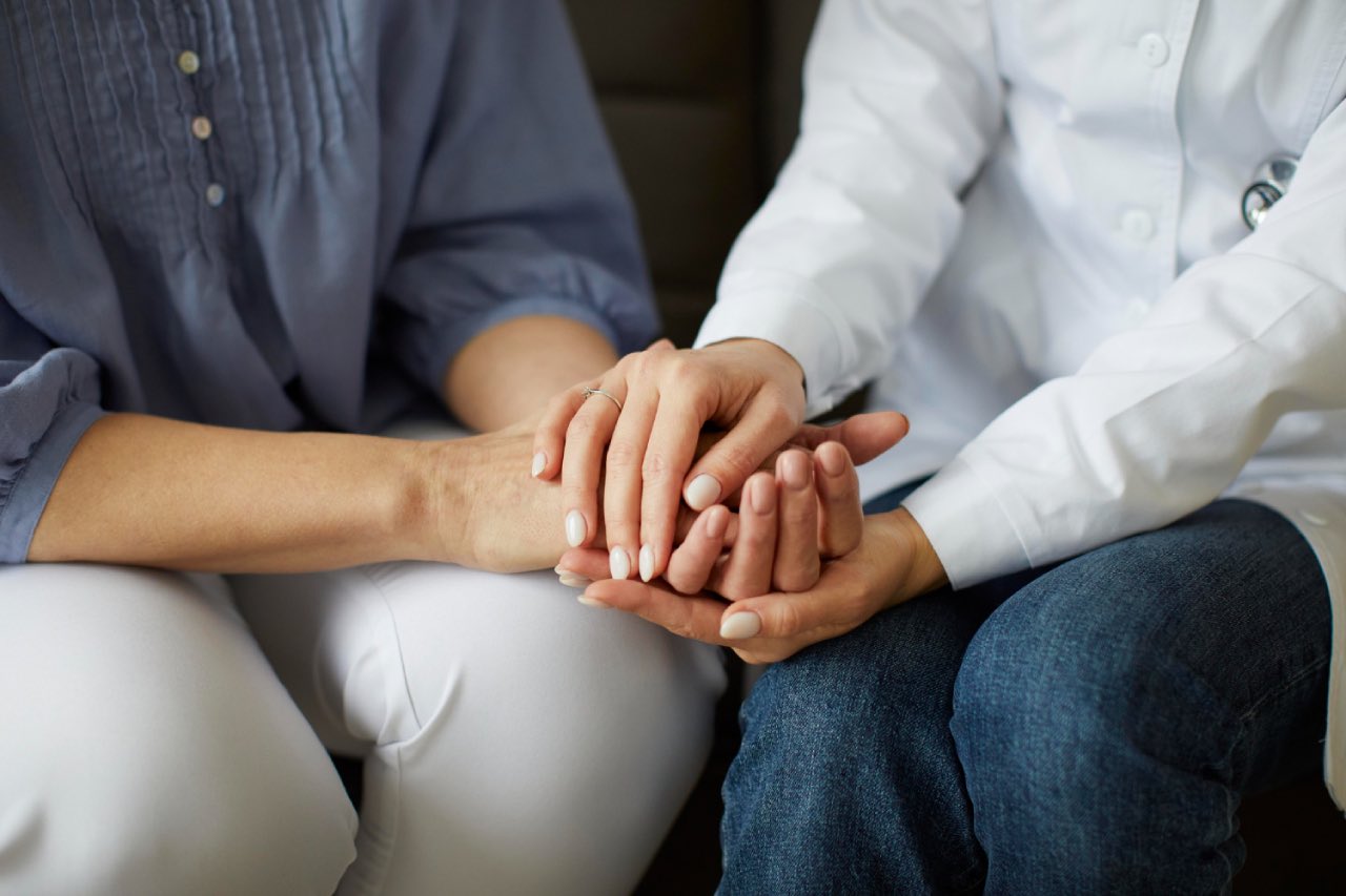 A female GP doctor caring and speaking to a patient about mental health